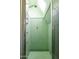 Small shower with mint green tile and skylight at 363 E Monte Vista Rd, Phoenix, AZ 85004