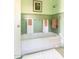 Retro bathroom with mint green tile, bathtub, and shower at 363 E Monte Vista Rd, Phoenix, AZ 85004