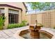 A courtyard with fountain, brick walls, and lush landscaping at 363 E Monte Vista Rd, Phoenix, AZ 85004