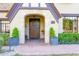 Inviting entryway with a wooden door and lush landscaping at 363 E Monte Vista Rd, Phoenix, AZ 85004