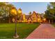 Evening view of Tudor home with lights illuminating the landscape at 363 E Monte Vista Rd, Phoenix, AZ 85004