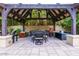 Outdoor patio area with a large dining table under a wooden pergola at 363 E Monte Vista Rd, Phoenix, AZ 85004