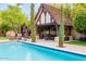 Relaxing pool scene featuring a shaded patio area with seating at 363 E Monte Vista Rd, Phoenix, AZ 85004