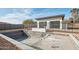Under-construction swimming pool surrounded by a safety fence with a modern building in the background at 2136 E Paradise Ln, Phoenix, AZ 85022