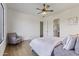 Bedroom with hardwood floors, a ceiling fan, a chair, and a window at 2285 E Chandler Heights Rd, Chandler, AZ 85249