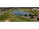 Aerial view of community pond and golf course surrounded by lush green space at 12075 N San Clemente St, Surprise, AZ 85388