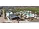 Resort-style community pool surrounded by palm trees, lounge chairs, and a covered patio area at 12075 N San Clemente St, Surprise, AZ 85388