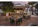 Elegant outdoor bar with ample seating, wood tables, comfortable chairs and brick pavers at 12075 N San Clemente St, Surprise, AZ 85388