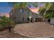 Spacious backyard featuring a brick patio, a covered pergola, and desert landscaping at 12943 W Mclellan Rd, Glendale, AZ 85307