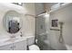 Modern bathroom with a glass-enclosed shower, stylish fixtures, and tiled walls at 12943 W Mclellan Rd, Glendale, AZ 85307