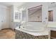 Bathroom with a large soaking tub and double sinks at 12943 W Mclellan Rd, Glendale, AZ 85307