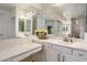 Elegant bathroom with double sink vanity, large mirror, and excellent lighting at 12943 W Mclellan Rd, Glendale, AZ 85307