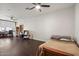 Spacious room featuring hardwood floors, ceiling fan, and natural light at 12943 W Mclellan Rd, Glendale, AZ 85307
