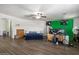 Bright bedroom featuring hardwood floors, ceiling fan, and ample natural light at 12943 W Mclellan Rd, Glendale, AZ 85307