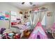 Cozy bedroom with built-in shelving, playful decor, and lots of personality at 12943 W Mclellan Rd, Glendale, AZ 85307