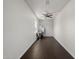 Clean, empty room with a window, ceiling fan, and hardwood floors at 12943 W Mclellan Rd, Glendale, AZ 85307