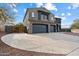 Two-story house with a large driveway and three-car garage at 12943 W Mclellan Rd, Glendale, AZ 85307