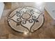 Elegant circular floor medallion in the entryway at 12943 W Mclellan Rd, Glendale, AZ 85307