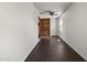 Hallway with dark floors and shelving unit at 12943 W Mclellan Rd, Glendale, AZ 85307