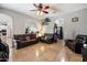 Comfortable living room featuring plush leather seating, neutral walls, and an open doorway at 12943 W Mclellan Rd, Glendale, AZ 85307