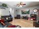 Cozy living room with an entertainment center, leather sofa, and open archways to other rooms at 12943 W Mclellan Rd, Glendale, AZ 85307