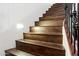 Dark brown wooden stairs with an iron railing at 12943 W Mclellan Rd, Glendale, AZ 85307