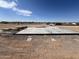 A concrete slab foundation for a house being built in a neighborhood in the desert at 10784 E Angus Ln, Coolidge, AZ 85128