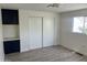 This bedroom features a closet, built-in storage, and light gray wood-look flooring at 11411 N 91St Ave # 217, Peoria, AZ 85345