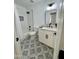 Well-lit bathroom features white cabinets, quartz counters, tile floors, and updated fixtures at 5984 W Geronimo Ct, Chandler, AZ 85226