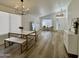 Dining room showcases wood flooring and a modern table with marble top and metal frame at 5984 W Geronimo Ct, Chandler, AZ 85226