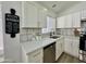 Close-up of a modern kitchen featuring bright white cabinets and stainless-steel appliances at 5984 W Geronimo Ct, Chandler, AZ 85226