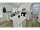 Modern kitchen with an island, stylish lighting, and stainless-steel appliances at 5984 W Geronimo Ct, Chandler, AZ 85226