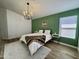 Main bedroom features a wood accent wall, lots of natural light, and wood-look floors at 5984 W Geronimo Ct, Chandler, AZ 85226
