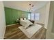 Main bedroom features a wood accent wall, modern decor, and lots of natural light at 5984 W Geronimo Ct, Chandler, AZ 85226