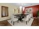 Elegant dining room features a dark wood table, white chairs, and stylish light fixtures at 1553 E Zion Way, Chandler, AZ 85249