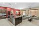 Open kitchen and living area with large island, dark cabinetry, and comfortable seating at 1553 E Zion Way, Chandler, AZ 85249