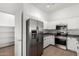A well-organized kitchen with white cabinets and stainless steel appliances, next to a pantry at 2402 E 5Th St # 1481, Tempe, AZ 85288