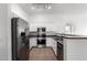 Clean kitchen with white cabinets, stainless steel appliances, and tile flooring at 2402 E 5Th St # 1481, Tempe, AZ 85288