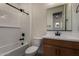 Bathroom featuring wood vanity, shower-tub combo, and a neutral tile floor at 2878 N Evergreen St, Buckeye, AZ 85396