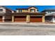 Exterior view of tan two-story home with brick pavers leading to a two-car garage at 2878 N Evergreen St, Buckeye, AZ 85396