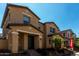 Exterior view of tan two-story home with inviting front yard and landscaping at 2878 N Evergreen St, Buckeye, AZ 85396