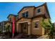 Exterior of a tan two-story home with covered entrance and landscaped yard at 2878 N Evergreen St, Buckeye, AZ 85396