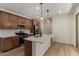 Contemporary kitchen features stainless appliances, a stylish island, and elegant pendant lights at 2878 N Evergreen St, Buckeye, AZ 85396