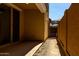 View of the covered patio with sliding glass door and view of backyard gate at 2878 N Evergreen St, Buckeye, AZ 85396