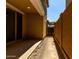 View of the covered patio with sliding glass door and view of backyard gate at 2878 N Evergreen St, Buckeye, AZ 85396