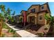 Street view showcasing a tan two-story home with landscaping and a sidewalk at 2878 N Evergreen St, Buckeye, AZ 85396
