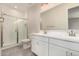 Modern bathroom featuring white dual sinks and a glass-enclosed shower with tile surround at 2888 N Evergreen St, Buckeye, AZ 85396