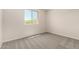 Bright, empty bedroom with neutral carpet and a large window at 2888 N Evergreen St, Buckeye, AZ 85396