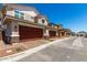 Brown two-car garage doors and stone veneer accents on this attractive facade at 2888 N Evergreen St, Buckeye, AZ 85396