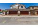 Facade with a pair of two-car garages with brown doors and stone veneer accents at 2888 N Evergreen St, Buckeye, AZ 85396